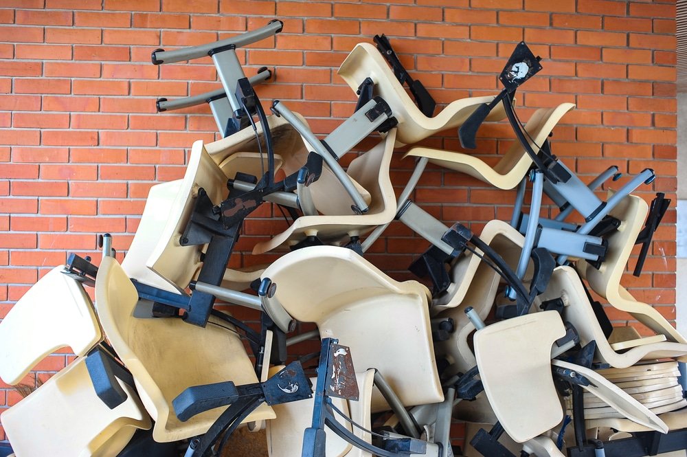 old chairs in pile for dumpster junk bin