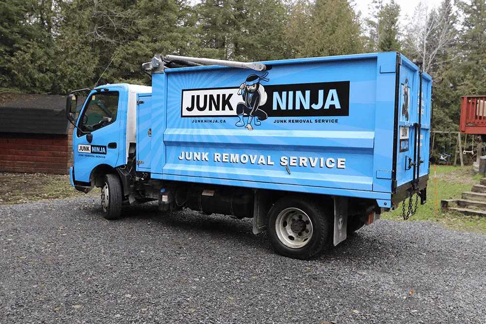 Blue Junk Ninja truck providing junk removal services in Ottawa area